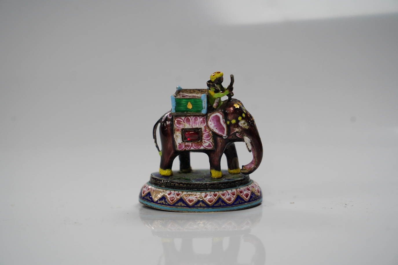 An Indian enamelled white metal elephant and mahout, 5cm. Condition - good